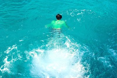 High angle view of boy swimming in sea