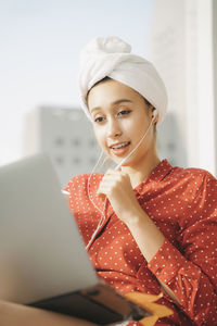 Portrait of young woman using mobile phone