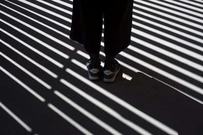 Low section of man standing on tiled floor