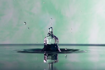 Close-up of drop falling on water
