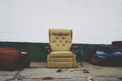 Chair on sofa against wall at home