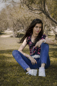 Young woman sitting on field