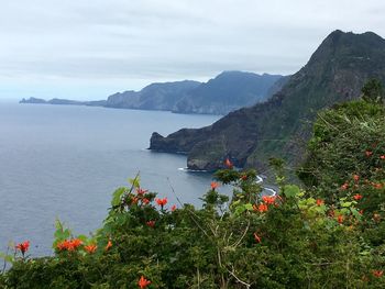 Scenic view of sea and mountains against sky