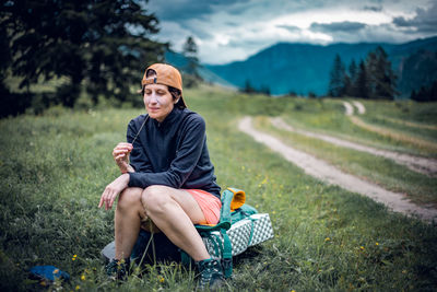 Full length of man sitting on field