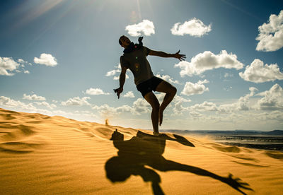 Man in the desert, happy and jumps, jumping in the desert celebrating her freedom