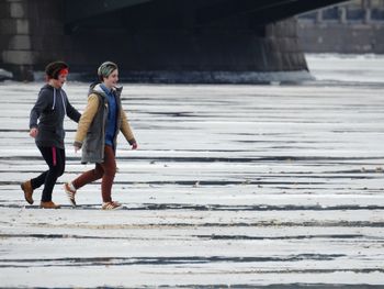 Side view of people walking on road