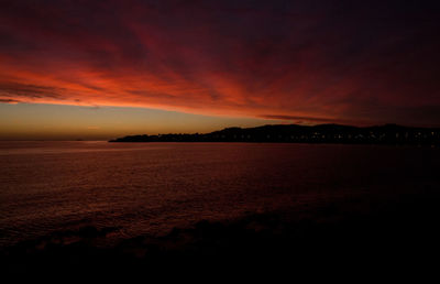 Scenic view of sea against romantic sky at sunset