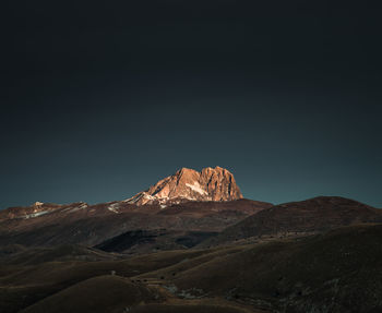 Scenic view of mountains against clear sky corno grande,abruzzo