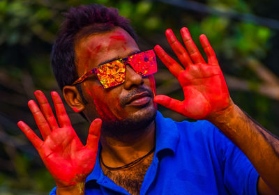 Portrait of a male indian celebrating holi with powder gulal. concept of the indian festival holi.