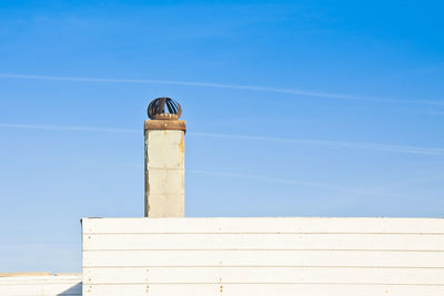 Low angle view of lighthouse against clear blue sky