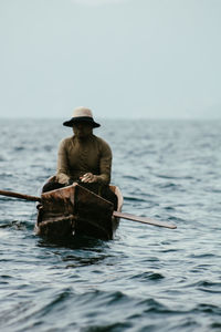 Rear view of woman swimming in sea