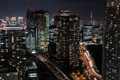 Illuminated modern buildings in city at night