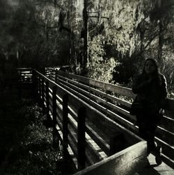 Woman on steps against trees