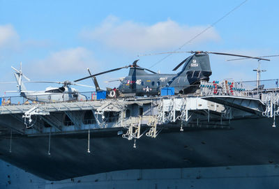 Ship moored at harbor against sky