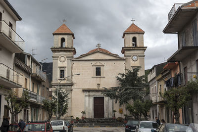 View of bell tower in city against sky