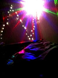 View of illuminated lighting equipment on bed