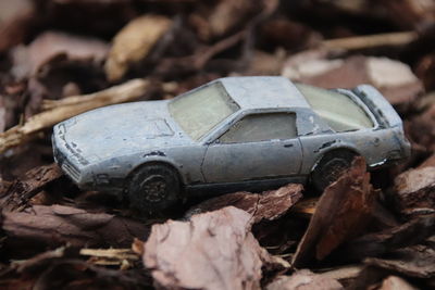 Close-up of abandoned toy car on field