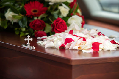 Closeup shot of a funeral casket or coffin in a hearse or chapel or burial at cemetery
