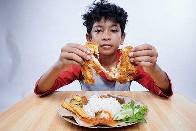 Portrait of young woman eating food