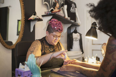 A beautician giving someone a manicure.