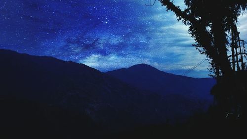 Low angle view of mountain range against blue sky