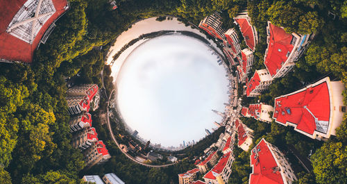 Low angle view of trees and buildings against sky