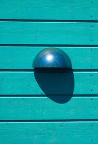 Close-up of metallic door on blue wall