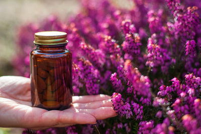 Close-up of hand holding glass jar