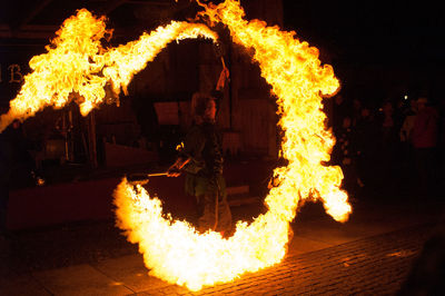 Fire juggler with 2 rotating torches