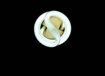 Close-up of illuminated electric light against black background