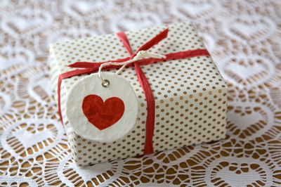 Close-up of heart shape label on gift at table