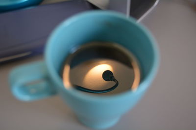 Close-up of lit candle in dark room