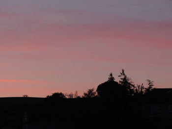 Silhouette trees against sky during sunset