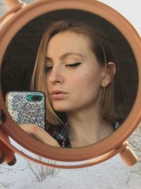 Portrait of young woman using mobile phone