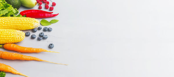 High angle view of fruits on table against white background