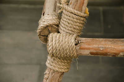 Close-up of rope tied on wooden post