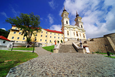 Low angle view of church amidst buildings against sky