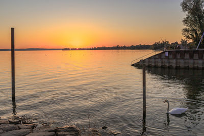 Scenic view of lake against sky during sunset