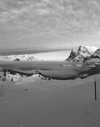 Scenic view of snow covered mountains against sky