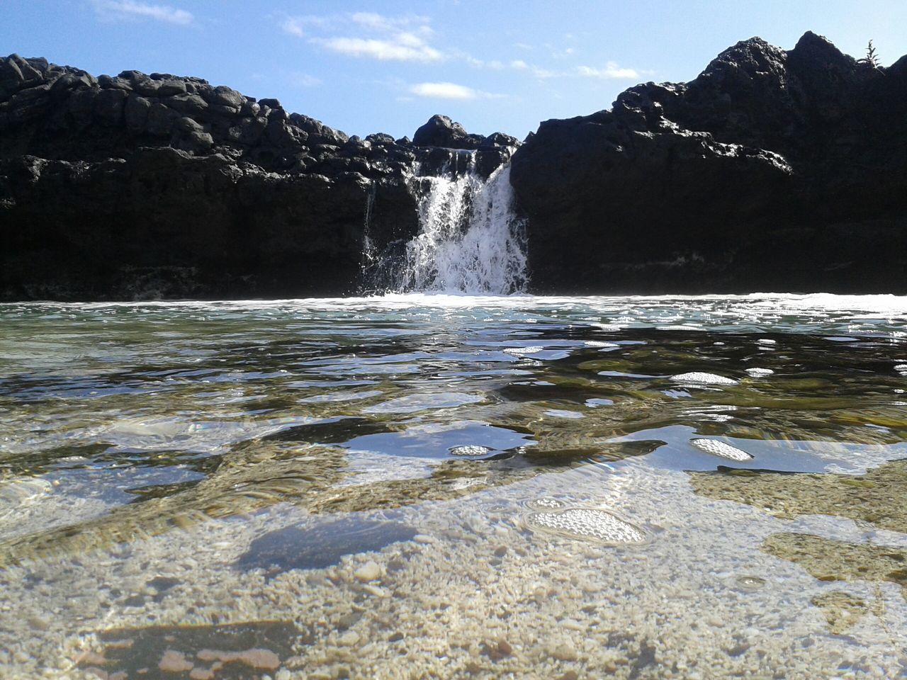 water, scenics, beauty in nature, mountain, tranquil scene, tranquility, rock - object, nature, sky, motion, idyllic, rock formation, lake, flowing water, non-urban scene, river, splashing, day, outdoors, no people