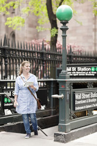 Smiling woman near subway station, new york city, usa