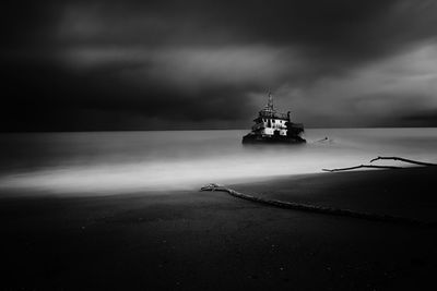 Boat sailing on sea against sky