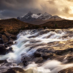 Scenic view of waterfall against sky