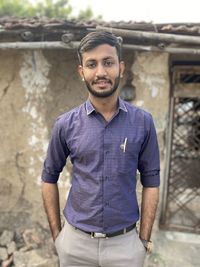 Portrait of young man standing outdoors