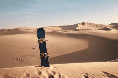 Scenic view of a sand board against desert and sky