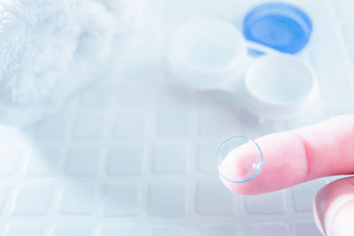 Close-up of hand holding white background