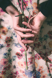 High angle view of woman hand on bed