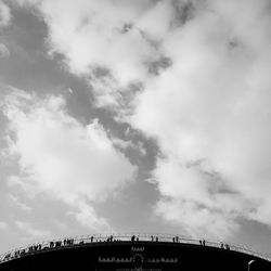 Low angle view of bridge against cloudy sky