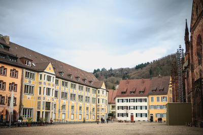 Residential buildings in town against sky