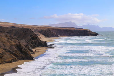 Scenic view of sea and mountains against sky